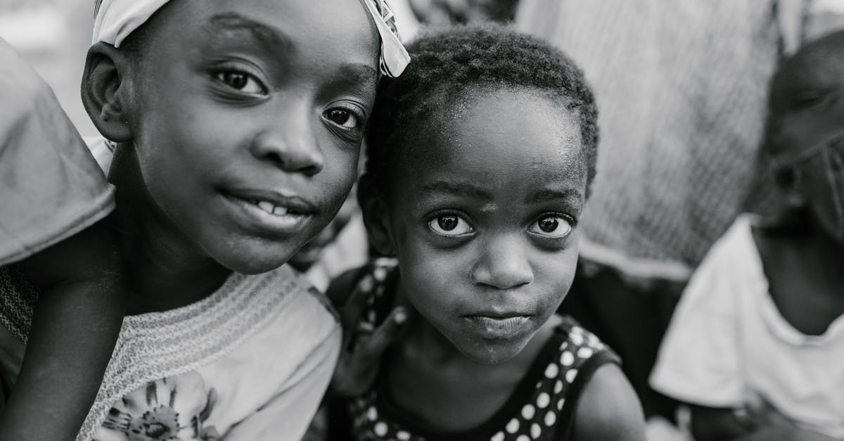 What is this original version of Tetris called? - Black and white glad children in casual clothes standing on authentic town street and looking at camera with curiosity