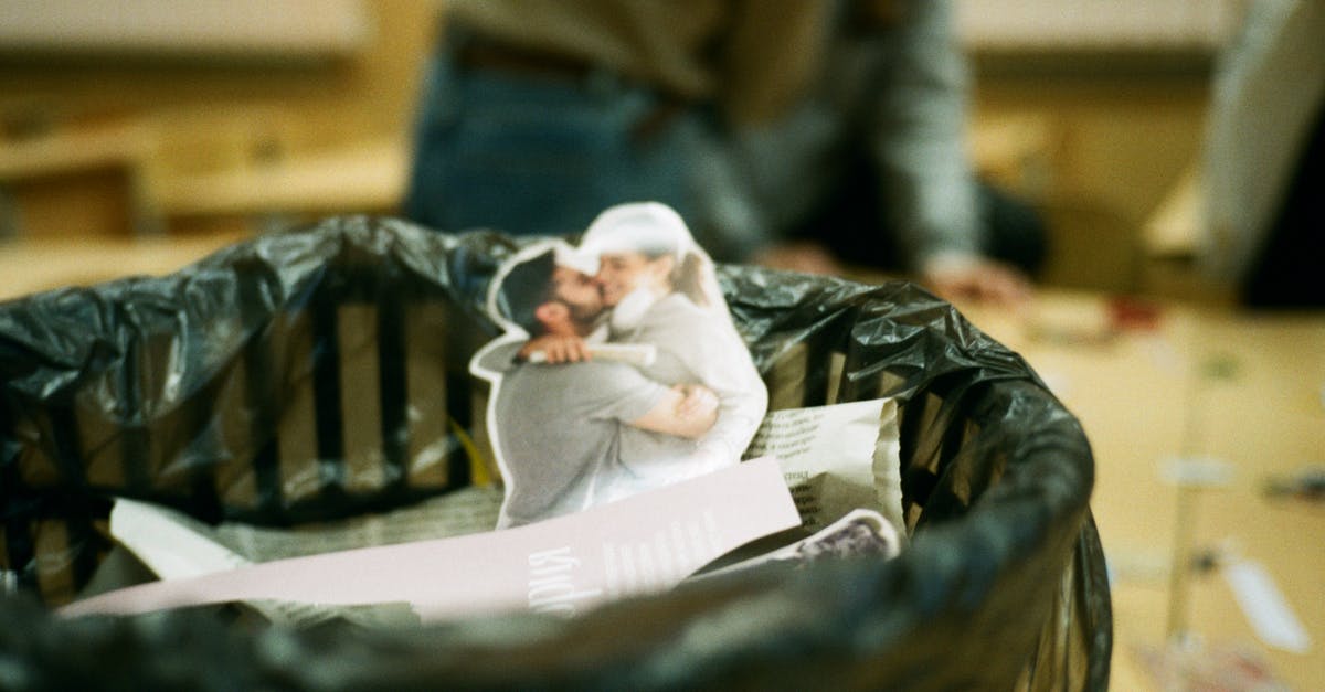 What items can you get from goodie bags? - Cut photo of embracing couple in rubbish can