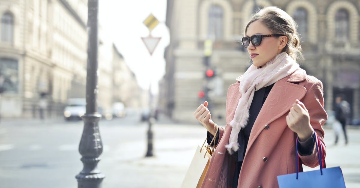 What items can you get from goodie bags? - Woman in Pink Coat Holding Shopping Bags