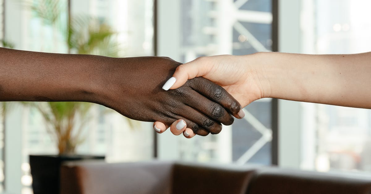 What jobs are in the Mime (reskinned Criminal) career track in the mainland China release? - Crop anonymous diverse women shaking hands together on blurred background of contemporary office