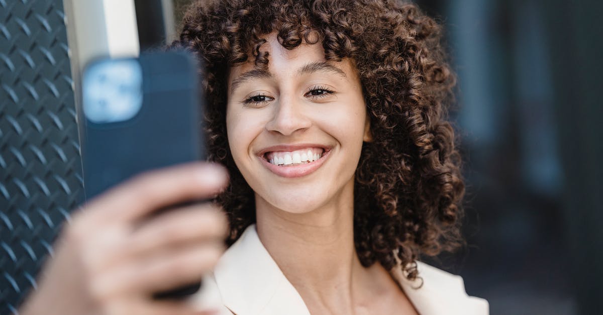 What kind of tarot is used in Persona 5? - Positive young ethnic female with curly brown hair taking self shot on cellphone in town on blurred background What kind of tarot is used in Persona 5? - Positive young ethnic female with curly brown hair taking self shot on cellphone in town on blurred background