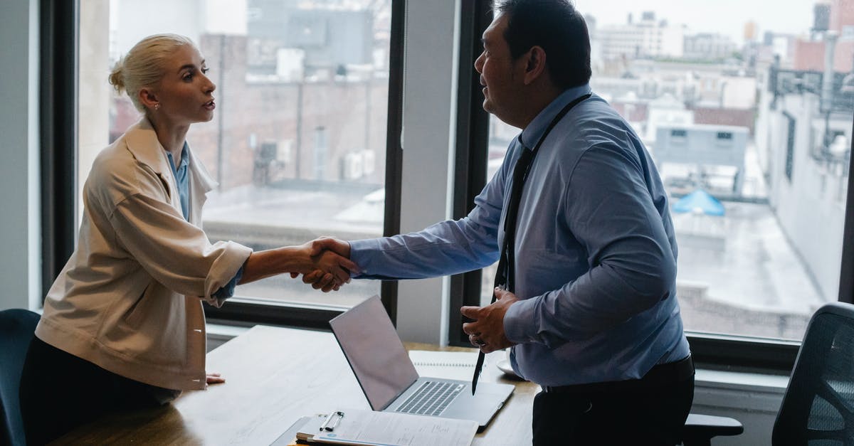 What makes a heist "Successful"? - Young woman shaking hands with boss after business presentation