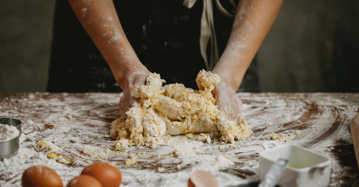 What makes surfaces portal-able? - Unrecognizable person preparing dough while standing at table with eggs covered with flour in kitchen during cooking process at home What makes surfaces portal-able? - Unrecognizable person preparing dough while standing at table with eggs covered with flour in kitchen during cooking process at home