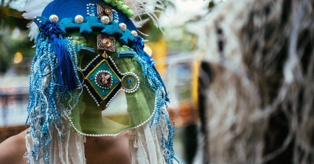 What mask is this? - Woman in Blue Yellow and Green Floral Headdress What mask is this? - Woman in Blue Yellow and Green Floral Headdress