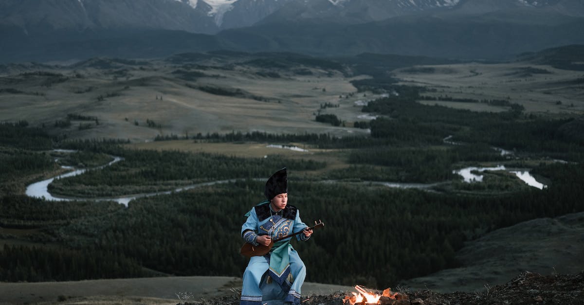 What Melodies can i play to my Mountain? - Young Mongolian male musician playing dombor in valley