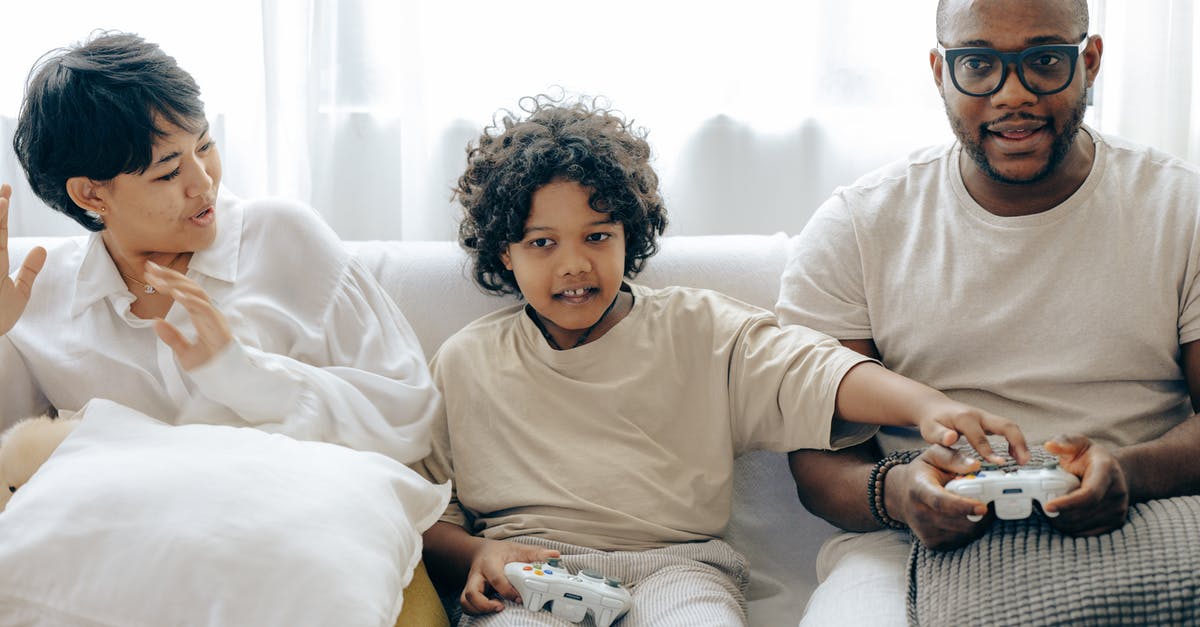 What online multiplayer features do the Half-Life games have? - Interested ethnic kid preventing father from winning in video game while resting together with mother in living room What online multiplayer features do the Half-Life games have? - Interested ethnic kid preventing father from winning in video game while resting together with mother in living room