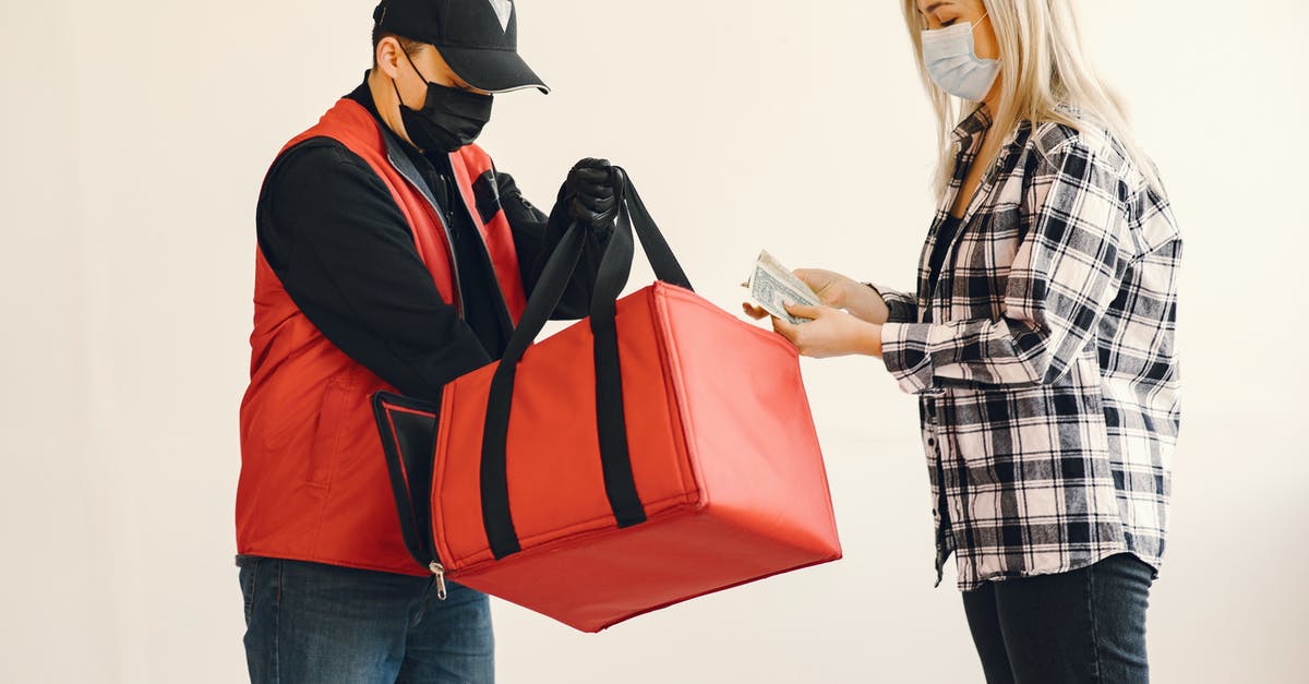 What percentage do specific foods add to the disease risk pool on survival difficulty? - Young blond woman in checkered shirt and medical mask paying cash to young delivery man in protective mask and gloves during safety food delivery in studio