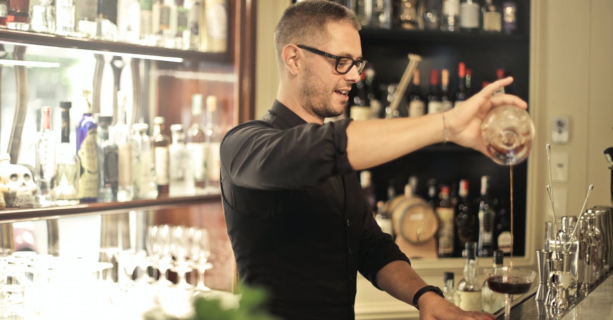 What purpose, if any, do skill points serve once you have unlocked all perks? - Side view of positive young barman in black uniform and eyeglasses pouring wine into glass while working at bar counter in modern restaurant
