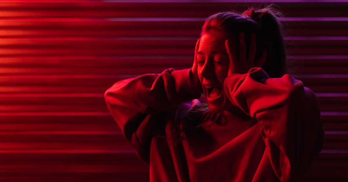 What regions do Red Beacons/Supply Caches usually appear in? - Shouting woman with hands on head in dim red light