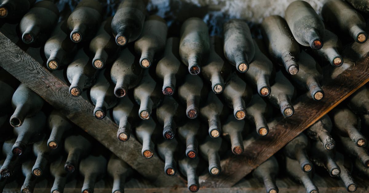 What sort of performance penalty does WINE cause? [closed] - From above of dusty bottles of alcohol drink placed above each other in rows in winery