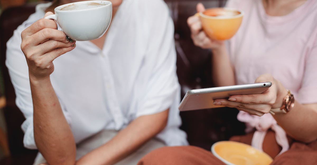 What special markup options are there in Discussions and how to use them? - Crop anonymous women in casual clothes drinking coffee and using tablet to discuss project What special markup options are there in Discussions and how to use them? - Crop anonymous women in casual clothes drinking coffee and using tablet to discuss project