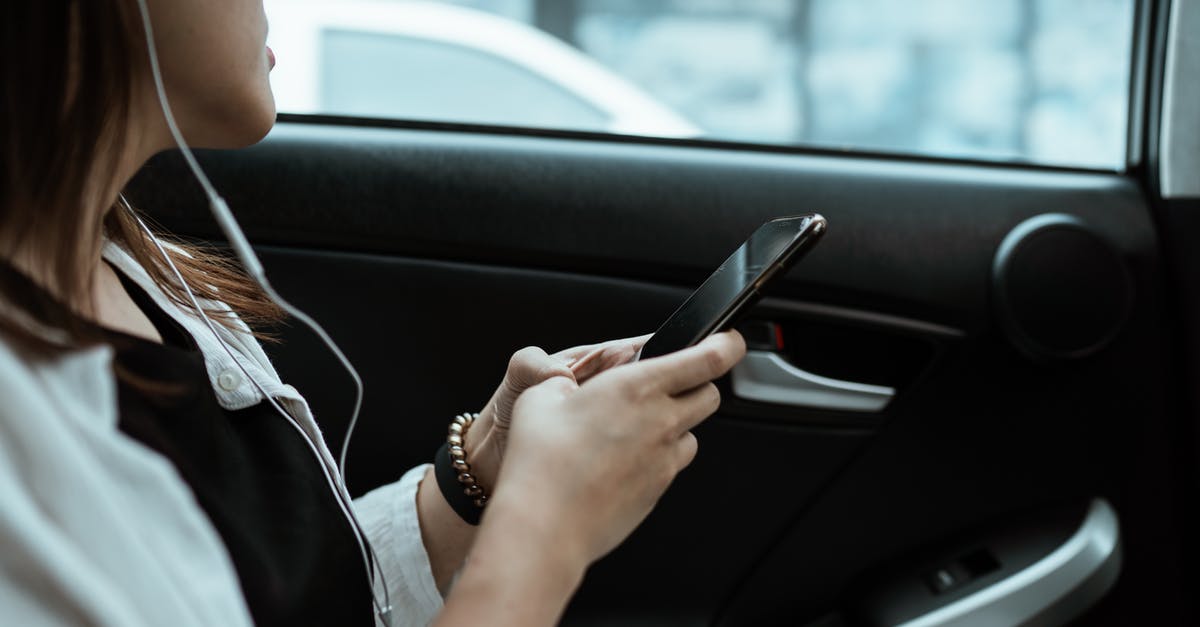 What super cars in GTA Online can have the armoured window upgrade? - Crop unrecognizable woman listening to music on smartphone in car