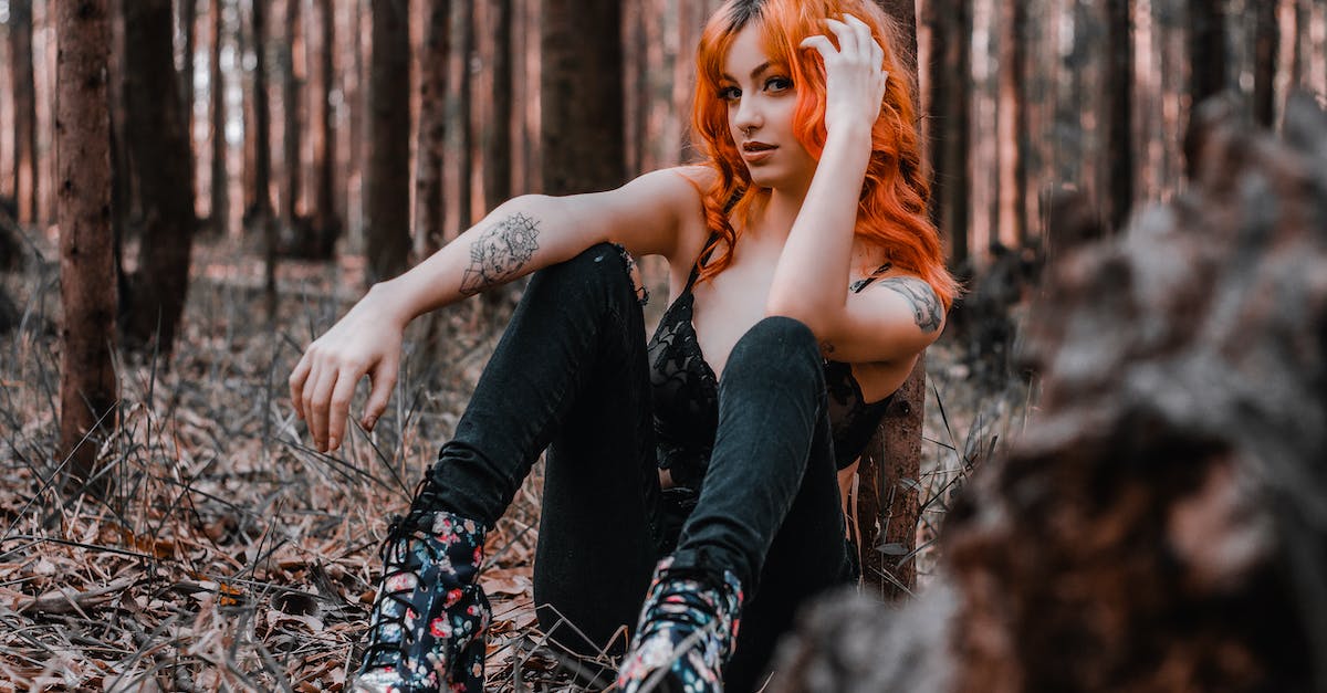 What Terraria content is unique to IOS? [duplicate] - Coquette female with red wavy hair sitting on grass in woods and touching hair while looking at camera