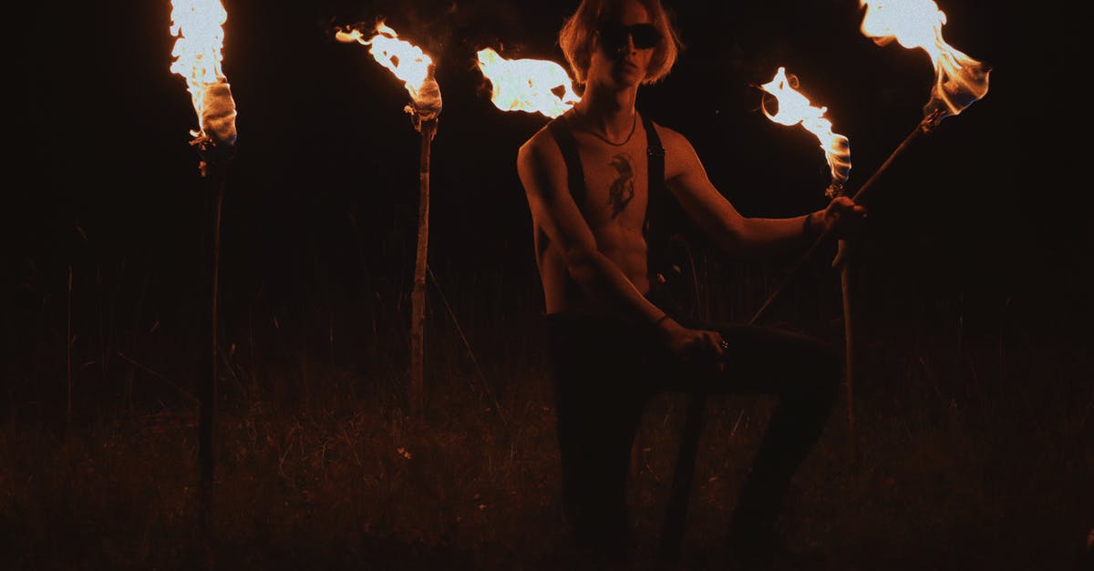 What to do when surrounded by more than one enemy in Free Fire? - A Man Kneeling on the Ground while Holding a Torch