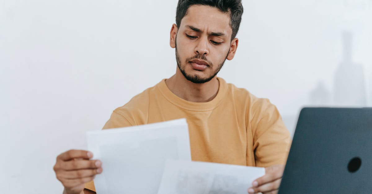 What type of buildings offer what level of jobs? - Man looking through documents at workplace What type of buildings offer what level of jobs? - Man looking through documents at workplace