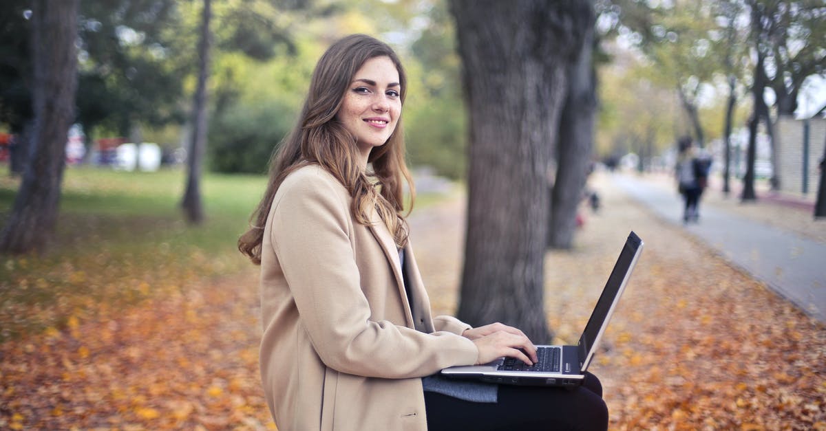What use are the Nature Sprites? - Joyful confident woman using netbook in park What use are the Nature Sprites? - Joyful confident woman using netbook in park