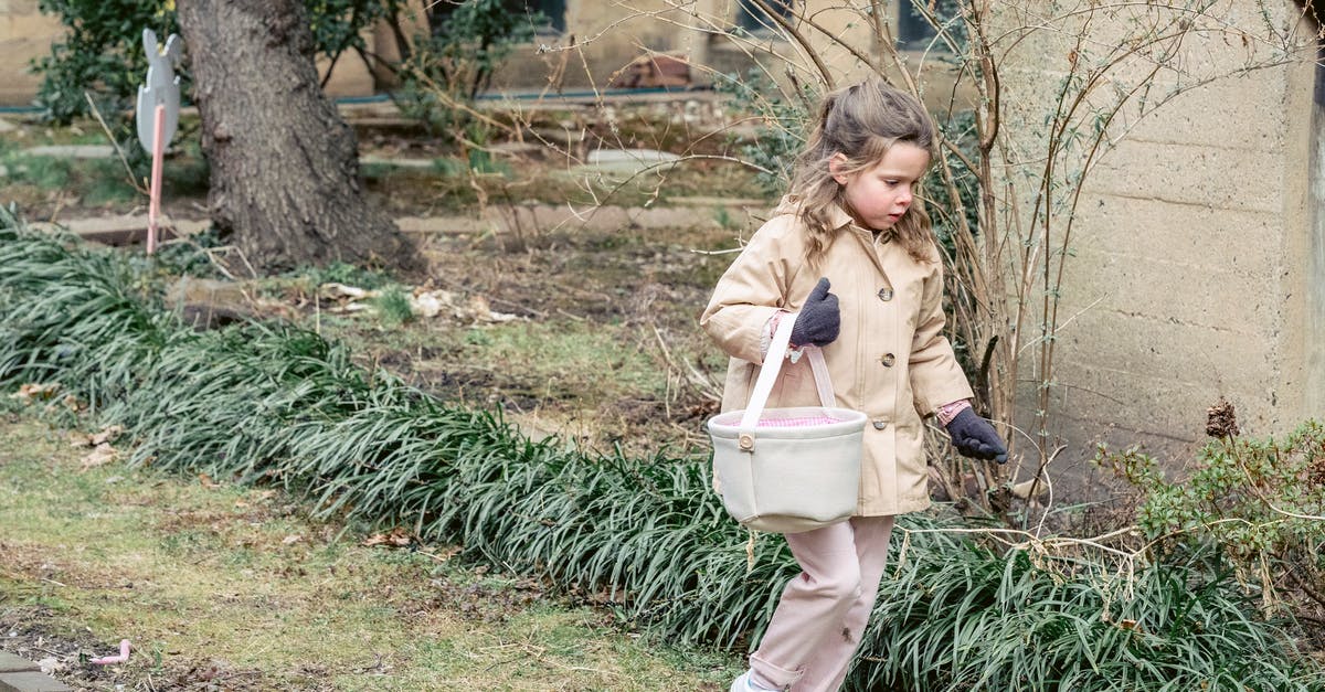 Whats happening if your pokemon bag is full and egg hatches? - Full length girl in warm clothes carrying fabric bucket and searching for hidden Easter eggs while walking in lush spring garden