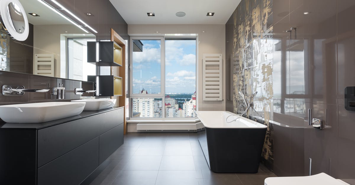Whats Master Chief's real name - Wooden furniture with bathtub and ceramic sinks and toilet bowl in contemporary master bathroom with big windows in daylight Whats Master Chief's real name - Wooden furniture with bathtub and ceramic sinks and toilet bowl in contemporary master bathroom with big windows in daylight
