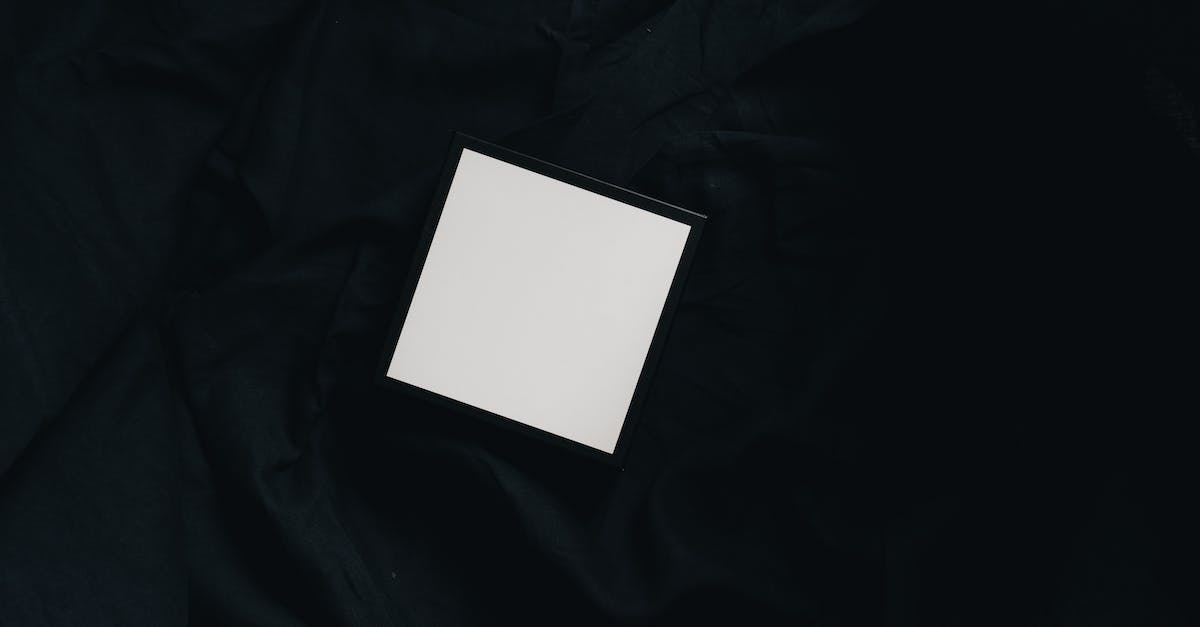 Whats the difference between a perfect pass and a good pass? - Top view of small white square carton present box with smooth surface and dense texture on black background