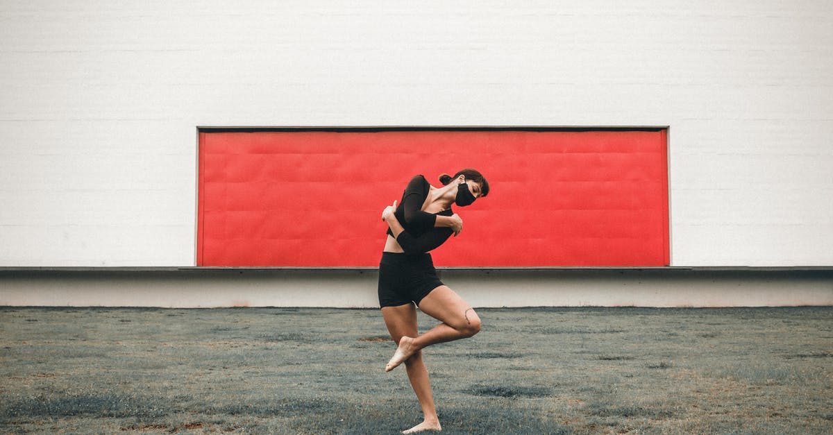 When can a spotted agent safely move into hiding? - Full body of flexible barefoot female dancer wearing protective mask standing on one leg while performing dance movement on street