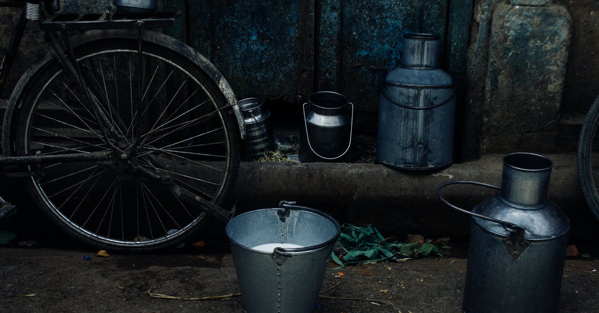 When can Super Troops be unlocked and which can I use if I maxed out the previous TH level? - Tin vessels and metal bucket with milk placed near bike leaned on shabby rusty wall