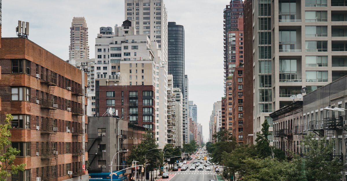 When do citizens of a new city adopt a religion? - New Your City street with vast busy road between contemporary typical buildings on clear day