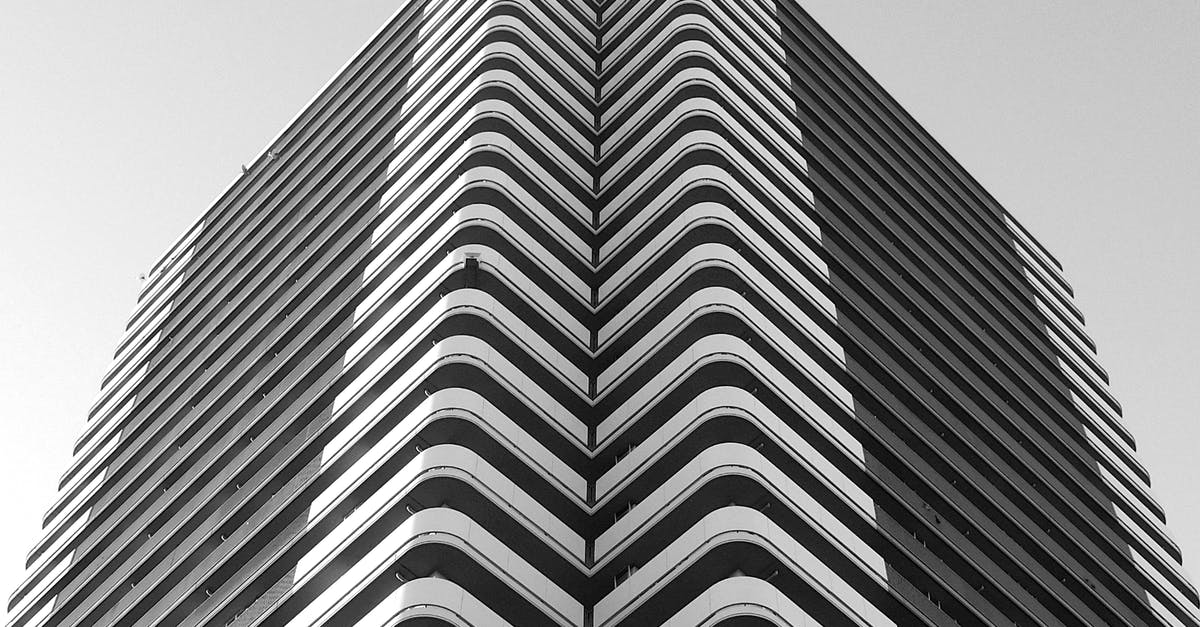 When do citizens of a new city adopt a religion? - Minimalist geometric building with curvy balconies in city When do citizens of a new city adopt a religion? - Minimalist geometric building with curvy balconies in city