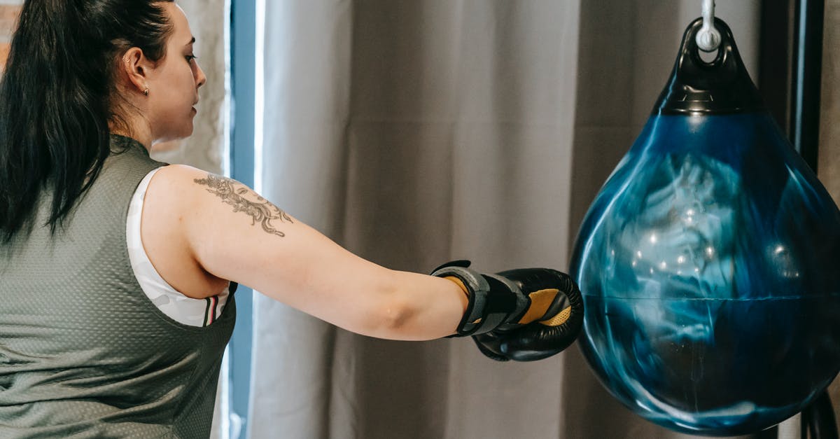 When do I punch the ball in Lucioball? - Female punching boxing ball during training in gym