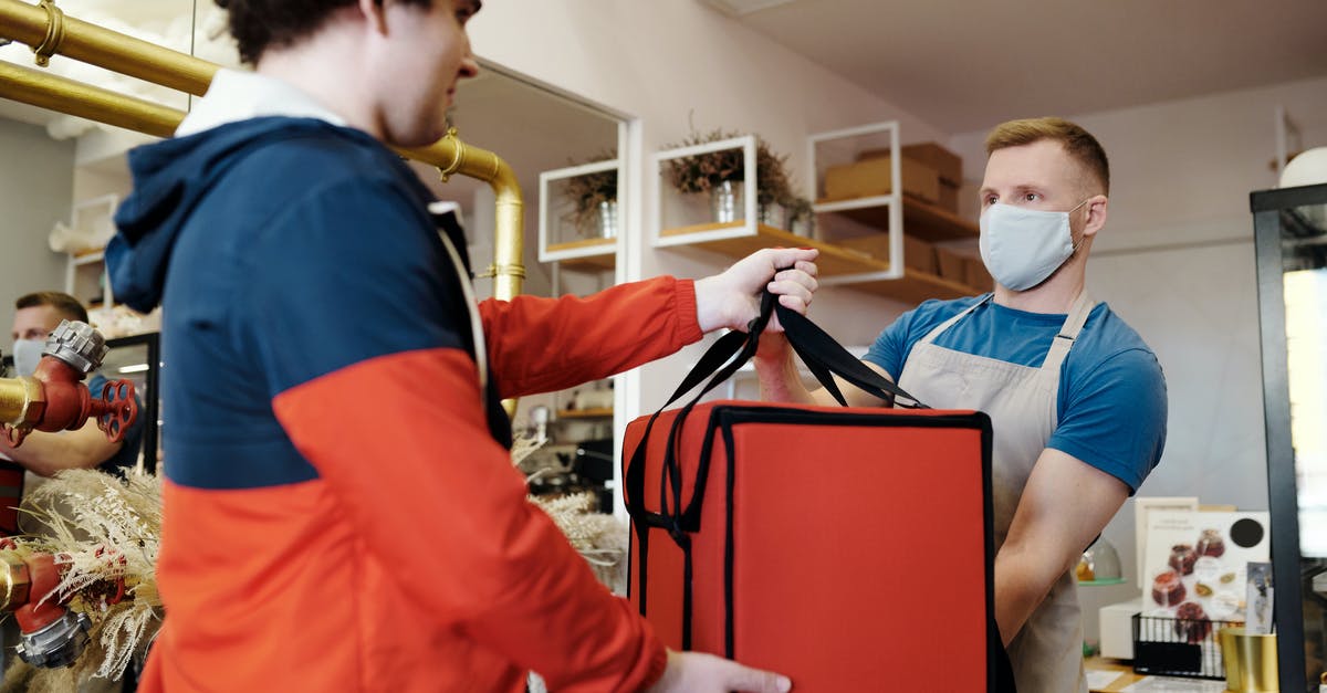 When do you get asked the questions in order to simulate a Witcher 2 savegame? - Man in a Face Mask Handing over a Thermal Bag to another Man When do you get asked the questions in order to simulate a Witcher 2 savegame? - Man in a Face Mask Handing over a Thermal Bag to another Man
