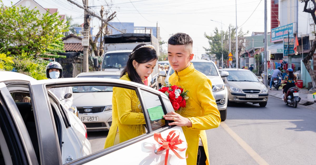 When does a Pokemon get knocked out? - Man in Yellow Long Sleeve Shirt Holding Red and Yellow Flag Standing Beside White Car during