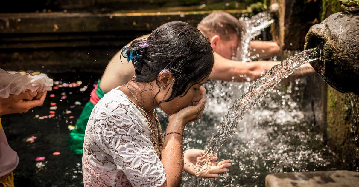 When does Katrina offer purification after bad luck in ACNH? - Man and Woman Bathing on Running Water