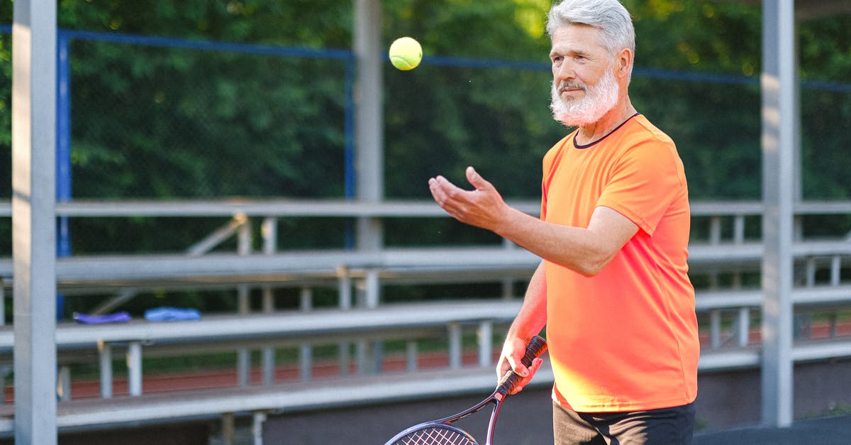 When does the game determine which fossils are which? - Focused elderly man playing tennis on street