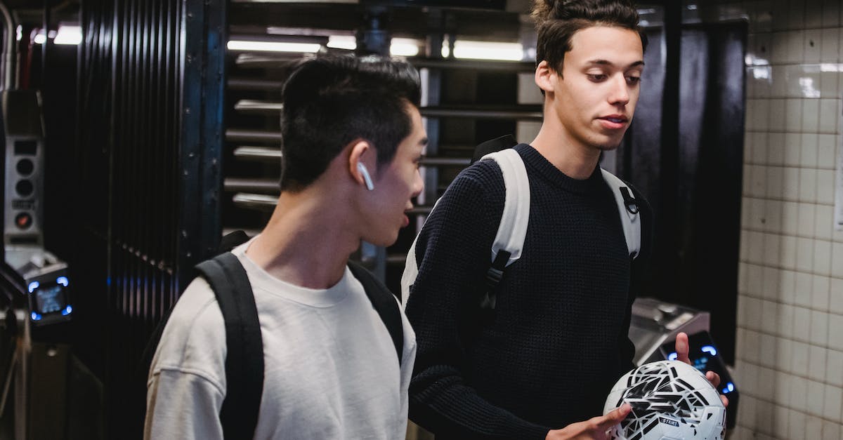 When does time pass in Norende? - Young men with soccer ball walking in metro station