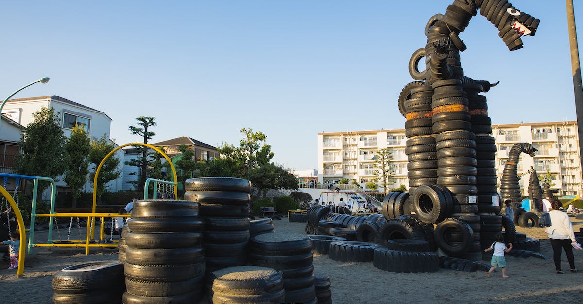 When exactly did everyone figure out about Lucy? - Suburb yard playground with stacks of old tyres constructed in huge monster creature