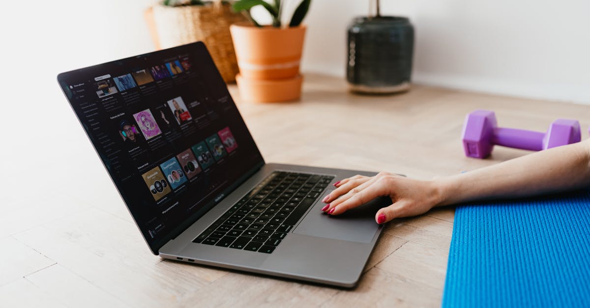 When exactly does the RDO tutorial end? - Hand of anonymous female on touchpad of laptop while surfing internet lying on mat at home during workout