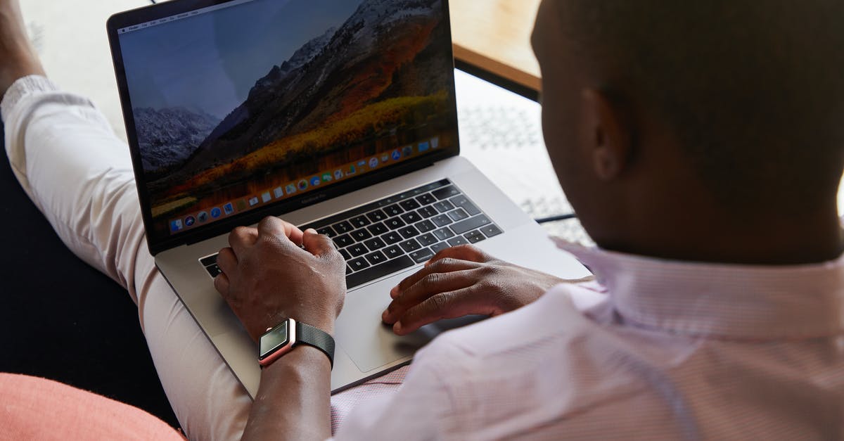 When I enter the Institute for the first time I can't progress - Black man with smart watch using touchpad of laptop