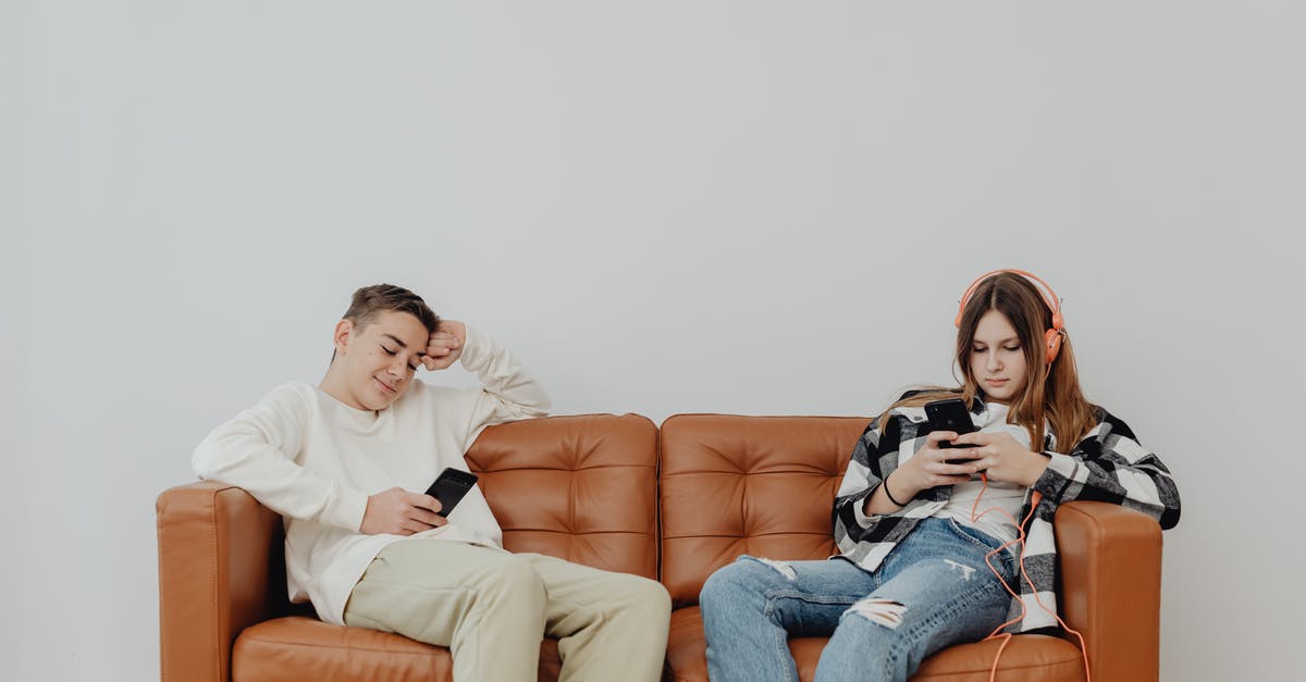 When should I be using wallride? - A Boy and a Girl Sitting on Sofa With Smart Phones in Hands