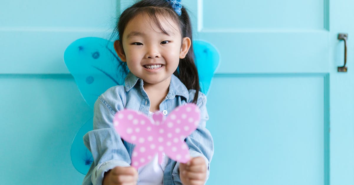 When should I choose Daedalus over Butterfly (or vice versa) when playing as Sniper? - Little Girl in Denim Shirt Holding a Polka Dot Paper Butterfly