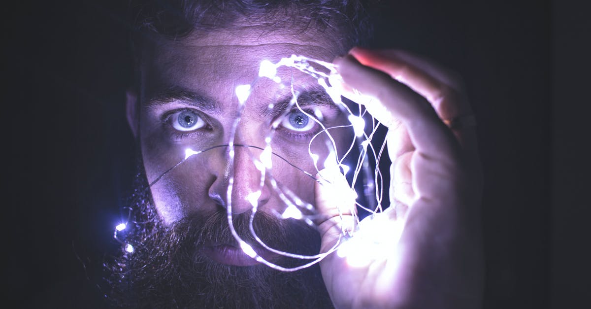 When should I chose to upgrade to the Greater Vision Totem? - Person Holding String Lights Photo