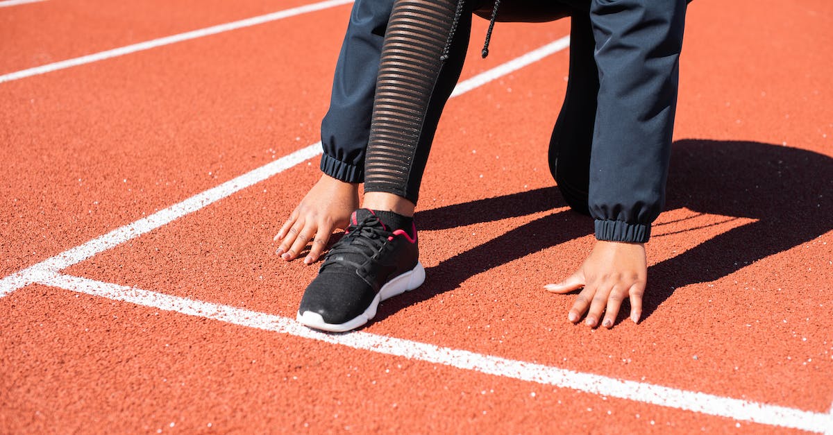 When should I start to increase the size of population? - Person in Black Pants and Black Leather Shoes Standing on Track Field