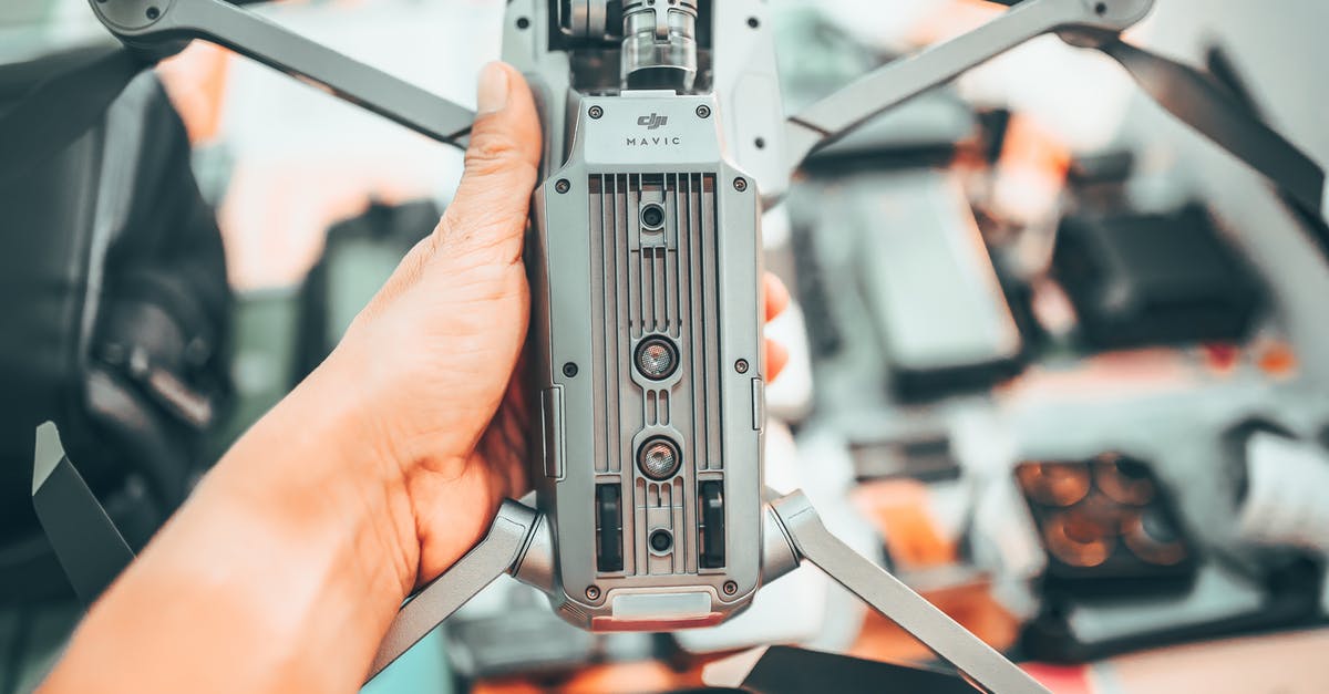 When should I use high gear? - Crop faceless man showing drone bottom part