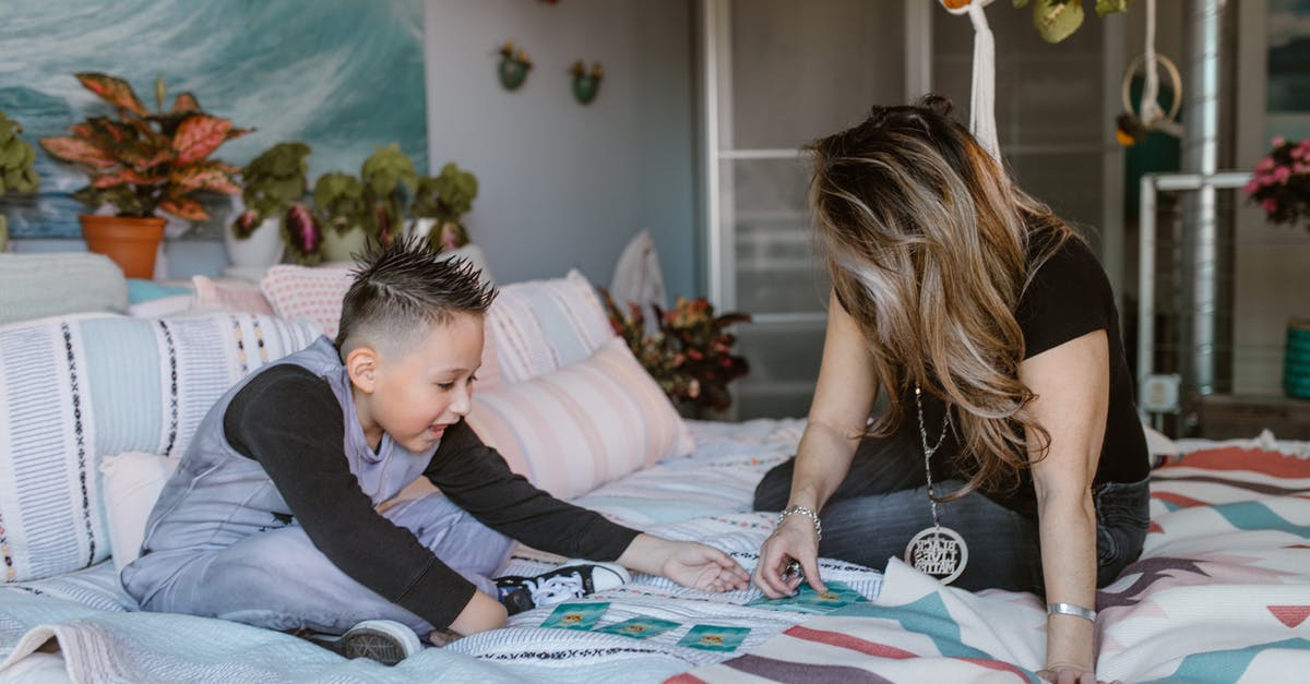 When unlocking a Variant card that requires two games, do I have to play them consequtively? - Young mother with preteen son playing cards on bed