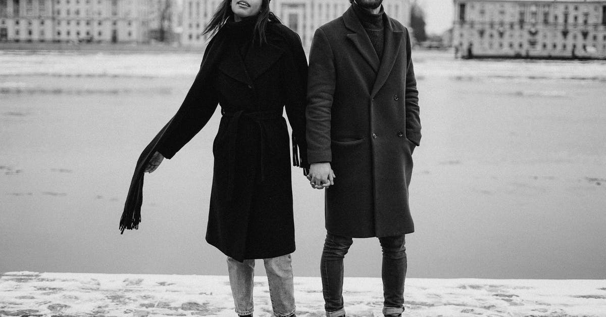 Where's the bobblehead stand? - Man and Woman Holding Hands on Black and White Photography