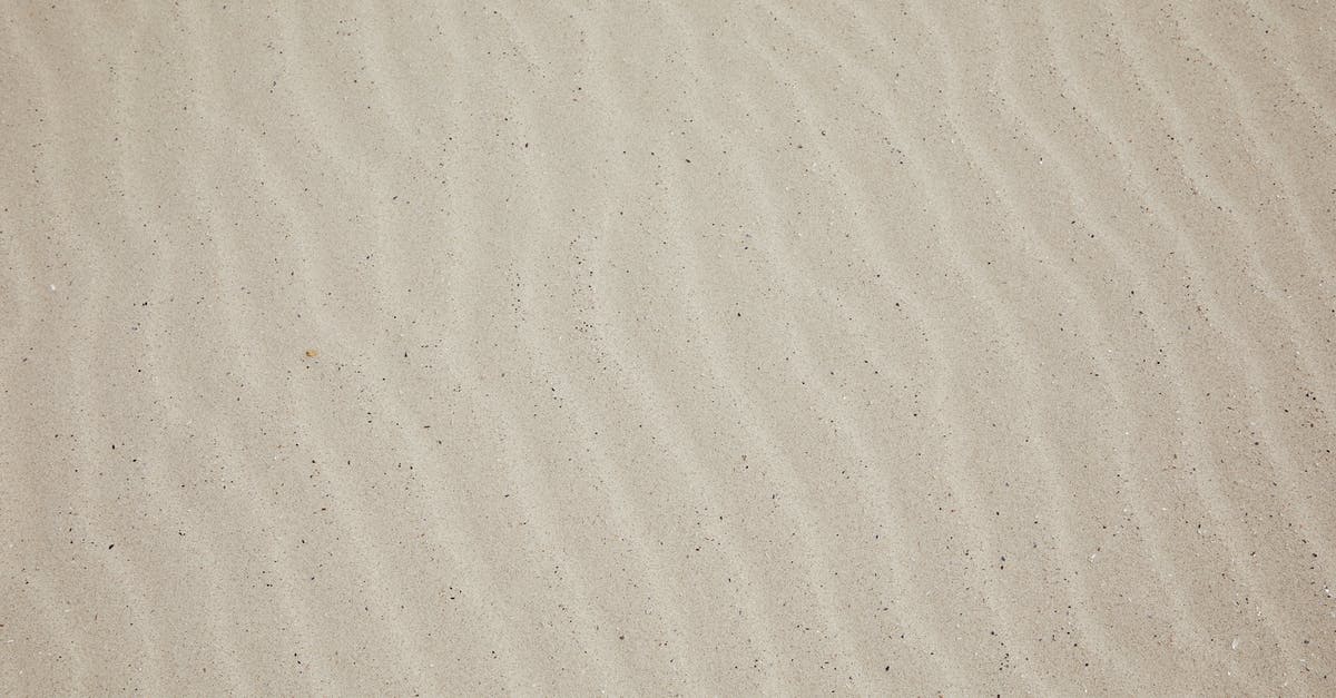 Where are all islands and discoverable locations? - Top view of empty dry plain surface of beach covered with sand in daytime
