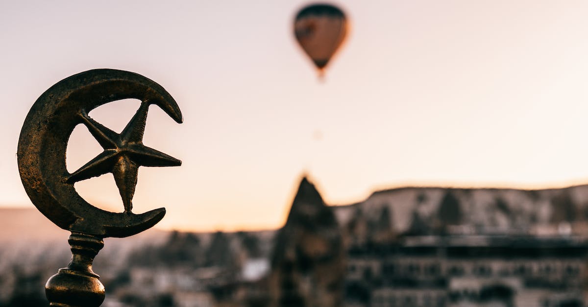 Where are all the star stones? - Soft focus of Turkey symbols on top of building against floating air balloon under Cappadocia terrain at dawn