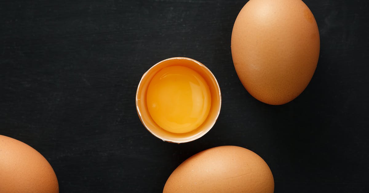 Where are the ingredient to enchant exceptional items? - Top view of whole and half of fresh chicken eggs with yolk representing uniqueness concept
