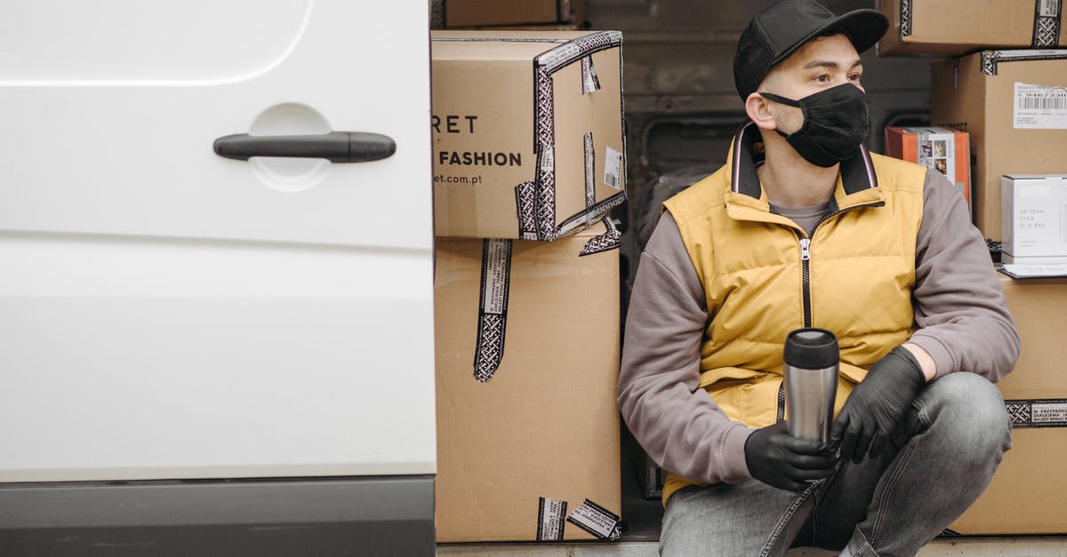 Where are the Silver Doors in the Labyrinth? - Man with Face Mask Sitting Near Brown Boxes