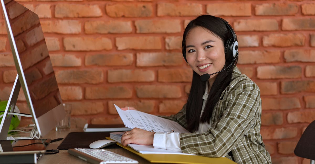 Where are the song files stored on my computer in Geometry Dash? - Smiling Woman with Headset Holding Files at Work