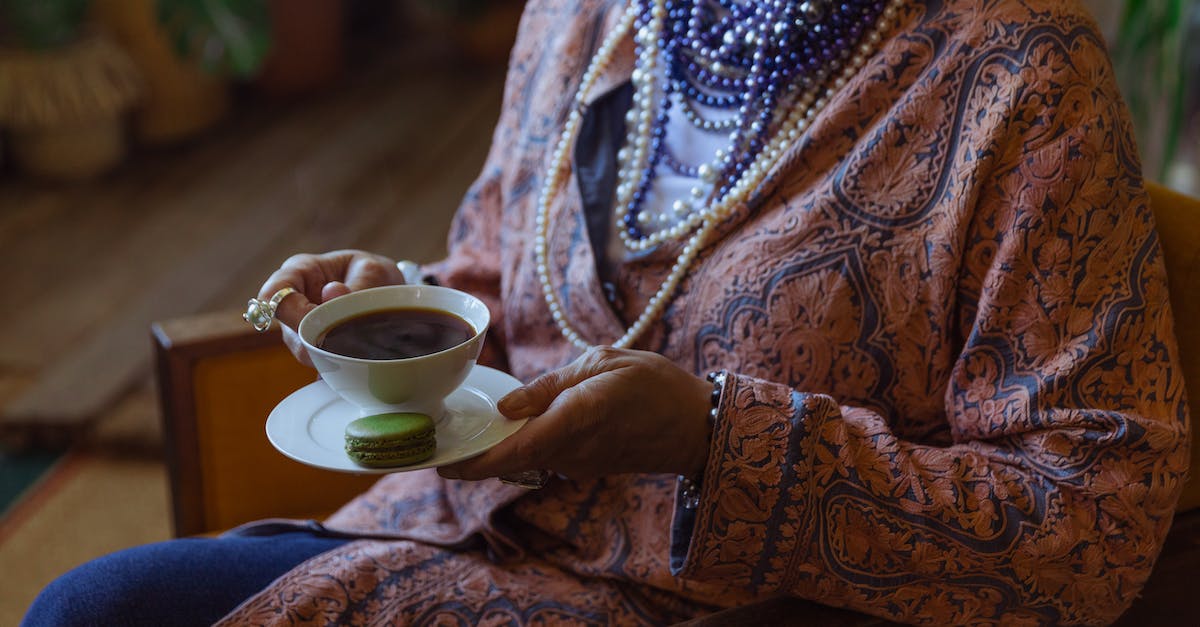 Where can I find pearls in Witcher 3 [after patch]? - Close-Up Photo of Person Holding Cup of Coffee