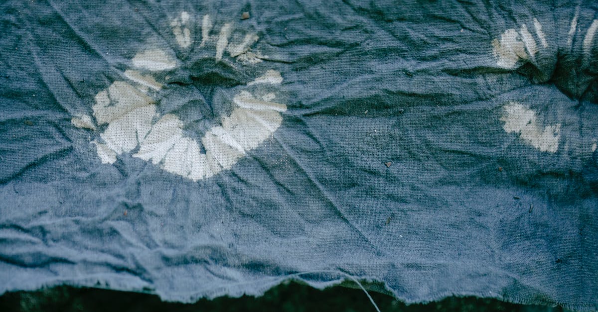 Where can I find Plant Fiber and Iron? - Texture of creased patterned fabric with uneven edge drying against plants with foliage Where can I find Plant Fiber and Iron? - Texture of creased patterned fabric with uneven edge drying against plants with foliage